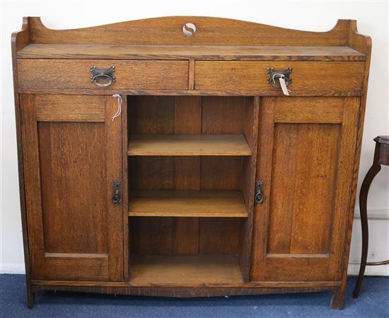 An Arts & Crafts oak bookcase W.137cm